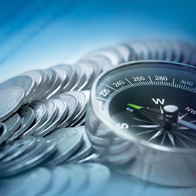 Compass leading to the right investment direction by Standard Chartered with coins
